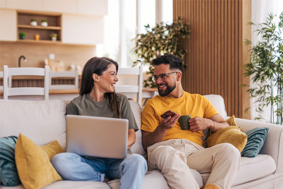 New homeowners celebrating outside their first house